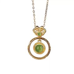 Material: S925 Sterling Silver with Gold PlatingGemstone: Jade, approximately 5mm (large), 2mm (small)Weight: Approximately 1.5gSize: Pendant Length: 22mm, Width: 15mm Description:Embrace timeless elegance with this Jade Double Circle Pendant Necklace. The design features a larger jade gemstone encased in a delicately twisted gold-plated S925 sterling silver frame, complemented by a smaller jade accent at the top. The double-circle structure offers a unique aesthetic that merges modern minimalism with traditional charm. This lightweight necklace is perfect for everyday wear, adding a refined touch to any outfit. The green jade's natural luster provides a subtle yet captivating appeal, making this piece an essential addition to your jewelry collection. Note: As jade is a natural gemstone, s Elegant Jade Necklace For Formal Occasions, Elegant Jade Necklace Round Shape, Elegant Jade Round Necklace, Elegant Round Jade Necklace, Jade Clavicle Chain Pendant Jewelry, Elegant Jade Necklaces As Gifts, Elegant Jade Necklaces For Gifts, Elegant Jade Necklace For Gifting, Elegant Jade Necklace As Gift