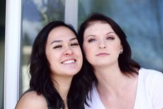 two women are smiling and posing for the camera