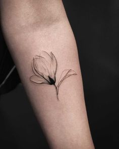 a black and white photo of a flower on the left arm, with an inking effect