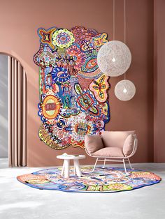 a living room with pink walls and an art work on the wall, two lamps hanging from the ceiling