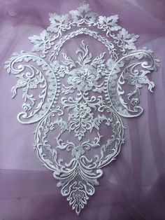 an intricate white lace design on a purple background