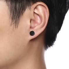 a close up of a person's ear with a black dot on the side