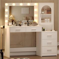 a white vanity with lights on it in a room