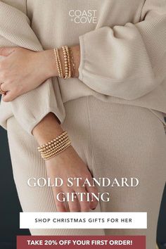 a woman wearing gold bracelets with the text, gold standard gifting shop christmas gifts for her take 20 % off your first order