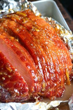 the meat is covered in sauce and sits on tin foil, ready to be cooked