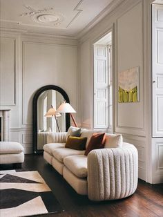 a living room filled with furniture and a mirror