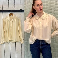 Elevate your everyday wardrobe with this vintage 90s ivory cream silk blouse from Calvin Klein. The shirt features balloon sleeves and ruffle detailing for a touch of femininity. The blouse is made from 100% silk, and its embellished features make it a standout piece.  This original vintage piece is in great condition and is perfect for any occasion. The size L blouse has a regular fit and a Hong Kong origin. The color is ivory, and the style is androgynous. Add this beautiful blouse to your collection and bring a touch of vintage elegance to your wardrobe. Era: 1990s Brand/maker: Calvin Klein Fabric content: silk Condition: excellent vintage condition, a few tiny marks but nothing noticeable  This item is washed and ready to wear. Fits like: large Shoulder: 17" Chest: 52" Length: 22" Slee Cream Silk Blouse, Cream Silk, Beautiful Blouses, Silk Crepe, Everyday Wardrobe, Silk Blouse, Womens Clothing Tops, Hong Kong, Vintage 90s