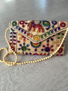 Indian handmade boho style handbag . hand embroidery all over . use as clutch bag or cross body . very lightweight Beige Clutch Shoulder Bag, Rectangular Clutch For Spring, Fashionable Beige Clutch Shoulder Bag, Spring Rectangular Clutch, Handmade Summer Pouch Satchel, Artisan Bag For Summer Gift, Handmade Pouch Satchel For Summer, Spring Bohemian Tote Shoulder Bag, Bohemian Spring Tote Shoulder Bag