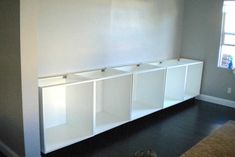 an empty room with white cabinets in it