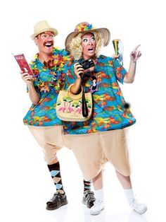 two people dressed in costumes and hats, one holding a cell phone while the other holds a book