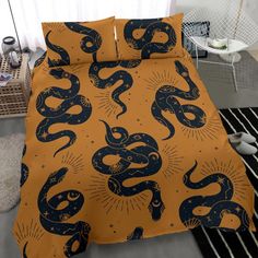 an orange and black bed with blue snakes on it