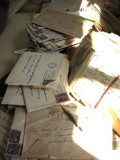 many old envelopes are piled on top of each other