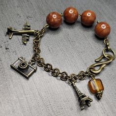 8" Length Nwt Antique Bronze Metal Charms, Plane, Eiffel Tower And Camera, Hand Looped Jump Ring Chain. Square Indian Glass Bead Brown Metal Beaded Bracelets With Round Beads, Brown Metal Beaded Bracelets As Gift, Brown Metal Beaded Bracelets For Gifts, Handmade Brown Charm Bracelet Gift, Handmade Vintage Adjustable Rosary Bracelet, Handmade Adjustable Vintage Rosary Bracelet, Paris Charm Bracelet, Travel Charm Bracelet, Charm Bracelet Watch