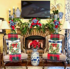 a living room filled with furniture and a fire place covered in christmas decorations on top of a mantel