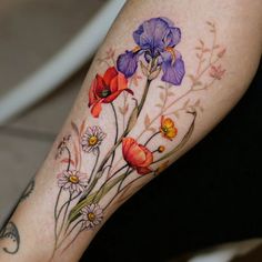 a woman's leg with flowers painted on it