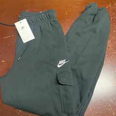 Nike Womens Black Sportswear Essentials Mid Rise Loose Fit Cargo Pants Size S Xl Brand: Nike Department: Women Size: S, Xl Color: Black Type: Pants Style: Cargo Pattern: Solid Theme: Sports Occasion: Activewear Season: All Season Features: Elastic Waist, Pockets Condition: New With Tags I Offer Discounts For All Return Customers. - Jvs Nike Sporty Cargo Pants For Sports, Sporty Nike Cargo Pants For Sports, Casual Sports Tracksuit With Pockets, Casual Tracksuit With Side Pockets For Sports, Nike Cotton Gym Pants, Nike Streetwear Bottoms With Side Pockets, Sportswear Tracksuit With Pockets For Gym, Cotton Athleisure Cargo Pants For Sports, Nike Sporty Cargo Pants With Pockets