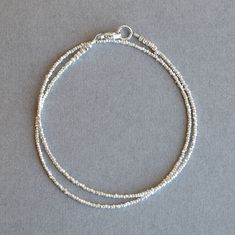 "Silver Wrap Bracelet Dainty Silver Bracelet for Women Hill Tribe Silver Fine Silver Bracelet Gift for Her Beautiful sparkling Hill Tribe double wrap silver bead bracelet. These beautiful silver beads are handmade in Thailand. It is pretty by itself or stacked with other bracelets for a great layered look. This is minimalist style bracelet that is made with VERY TINY beads that make it a lovely and dainty bracelet. The silver beads are faceted and give it a little sparkle. The bracelet is finish Simple Bracelets Silver, Small Beads Bracelet, Layered Silver Bracelets, Dainty Silver Bracelet, Silver Wrap Bracelet, Silver Bracelet For Women, Small Bead Bracelet, Silver Beaded Bracelet, Silver Bracelets For Women