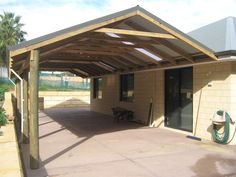 an outdoor covered patio area with a hose attached to it