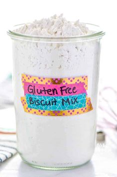 a jar filled with gluten free biscuit mix on top of a table