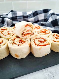 several rolls are stacked on top of each other and ready to be baked in the oven