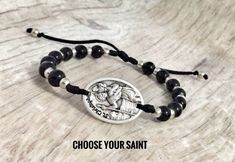 "Saint medal blessing bracelet is made by using 6mm glass beads and 0.9\" silver oxidized saint medal with great details Create your own bracelet choosing Saint medal and color of beads and we will make it for you. Handmade and has sliding slipknot for an easy fit.Adjustable cording which opens to 9.5\" diameter,closes to 6.25\". You can request a specific size as well. Medals made in Italy. Hand made in Medjugorje." Nickel-free Spiritual Rosary Bracelet Gift, St Dymphna, Catholic Bracelet, Blessing Bracelet, Catholic Saint, Beading Jewelery, Custom Bracelet, Small Bracelets, Catholic Jewelry