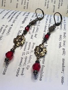 Romantic Red Floral Earrings - I used red crystals and antiqued brass flowers to give them a vintage look . They are approximately 2.5 inches long and come in a gift box or gift bag. Red Brass Earrings With Ear Wire, Vintage Red Brass Earrings, Red Brass Drop Earrings, Nickel Free Red Earrings For Anniversary, Nickel-free Red Earrings For Anniversary, Red Brass Earrings For Wedding, Elegant Red Flower Earrings With Ear Wire, Nickel-free Red Brass Earrings, Red Brass Jewelry For Anniversary