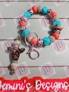 "Beaded AZTEC print Bangle bracelet wristlet Keychain with turquoise beads & dangle Keychain bar.  This Bangle wristlet Keychain fits easily over the wrist.  You roll it on and off.  This Keychain is not elastic.  One size fits most.  The opening measures approximately 3.5\".  If a larger or smaller size is wanted, please leave a note to seller. Never loose your keys again  Made of silicon beads  Follow me on Facebook for new and upcoming items. https://www.facebook.com/Jeminisdesigns  Please read the full policies before purchase. WARNING:  beads can pose a chocking hazard, please keep away from children" Adjustable Turquoise Beaded Dangle Bracelets, Adjustable Multicolor Wristlet With Lobster Clasp, Adjustable Orange Beaded Bracelet With Lobster Clasp, Dangle Keychain, Silicon Beads, Silicone Wristlet, Bead Projects, Turquoise And Coral, Tassel Keychain