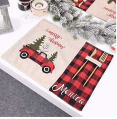 two placemats on a table with christmas decorations and utensils in front of them