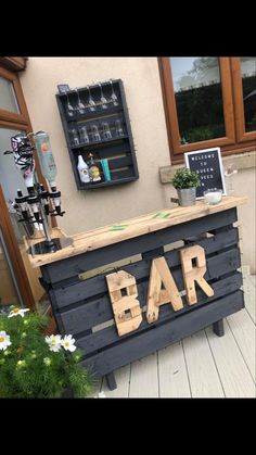 a bar made out of wooden pallets with the word bar written on it's side