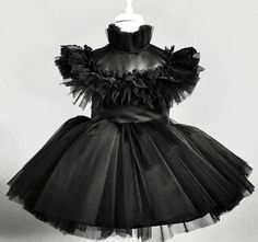 a black and white photo of a dress on a mannequin headdress