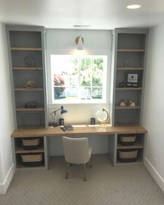 a home office with built in shelving and desk