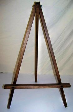 a wooden easel sitting on top of a white table