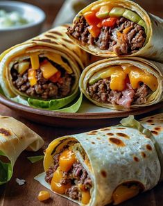 several burritos on a plate with cheese and meat in the middle, ready to be eaten