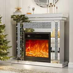 a living room with a fire place and christmas tree in front of the fireplace,