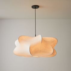 a light that is hanging from the ceiling in a room with white walls and flooring