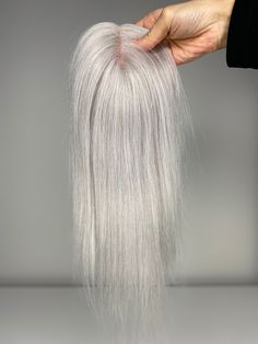 100% Human Virgin Remy Mono Hair Toppers All hand-tied mono base topper 2.75X 5" Color: #LightSilver A (Icy light silver almost white but not pure white) Weight: 38g, 48g 120% Density (This is for light coverage. If you need lots of hair for full coverage, we recommend you go with higher density or bigger base size.) Length: 12", 16" ✨Due to the processing differences, the color may be slightly different from our WIRE extensions, Clip-in extensions etc. in the same shade. ✨These Mono base toppers are made with ultra fine mesh material and the hair is hand-tied individually. They are breathable and light material and easy to maintain. Unlike the hair wigs , these hair toppers are more versatile for customers to apply, take care, and do hair style with. It will add volume in few minutes, ble Grey Hair Topper, Grey Hair Extensions, Silver White Hair, Hair Light, Clip In Extensions, Hair Toppers, Popular Hairstyles, Hair Photo, Light Hair