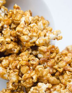 a white bowl filled with caramel popcorn