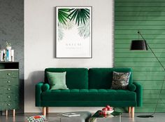 a living room with green couches and pillows on the floor in front of a white wall