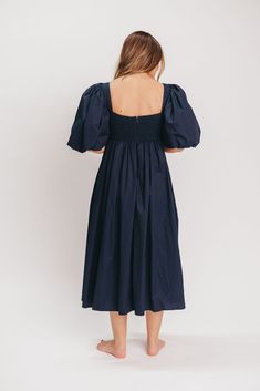 This gorgeous dress is a *vibe* and we are here for it. If you think the Harlow is stunning in photos, wait till you see it in person - this dress will make a statement wherever you go! It features incredible puffed sleeves, a bustier-style structured bodice, and a voluminous skirt. This navy gem is extra-luxe, and 100% the choice when you're looking to stand out from the crowd. Pair it with a glam set of pumps for a night at the symphony or a black tie wedding, and prepare yourself for the admiring glances! FIT: Please note that the bodice runs very true to size, but the smocked back panel does provide additional stretch. Some wearers with a C-cup and larger may find the bodice uncomfortable due to the structured bra cups. Please refer to the size chart and consider your chest size before Chic Midi Dress With Bishop Sleeves For Brunch, Chic Dresses With Bishop Elastic Sleeves, Chic Dresses With Bishop Sleeves And Elastic Details, Chic Voluminous Dress With Balloon Sleeves, Midi Dress With Bishop Sleeves For Brunch, Midi Dress With Bishop Elastic Sleeves, Chic Bishop Sleeve Dress For Brunch, Brunch Midi Dress With Bishop Sleeves, Chic Dress With Gathered Sleeves For Date Night