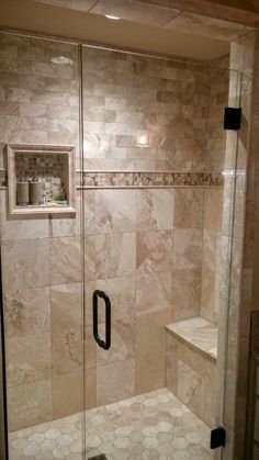 a walk in shower sitting next to a tiled wall and floor with a window above it