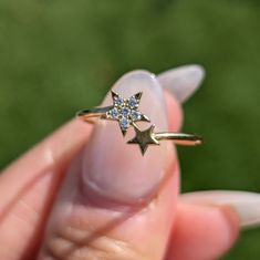 a person holding a tiny star ring in their hand