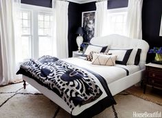 a bedroom with black walls and white furniture