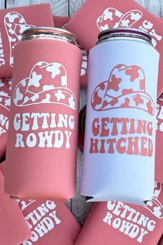 pink and white can coolers sitting on top of each other with the words getting rowdy printed on them