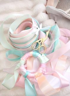 a pile of ribbons and scissors on top of a white furnishing area next to a pair of shoes