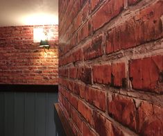 a brick wall with a lamp on it