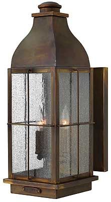 an old fashioned light fixture with glass panels on the front and back of it's head