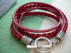 A Metallic Red Leather Bracelet.... Super stylish and feminine, wrap this twice around your wrist, toggle up and off you go. This Double Wrap Leather Bracelet features 3mm round, 3mm braided and 5mm flat braided metallic leather cords. Lead and Nickel Free - Aged Silver Toned Alloy Components, Secure Toggle Closure for Easy on and off. All dyes used in our leather are certified 100% Lead-Free and meet all requirements of the German Goods Ordinance, REACH (European Union), RoSH (U.K.), and CPSIA Adjustable Burgundy Bracelets, Trendy Red Adjustable Leather Bracelet, Red Adjustable Leather Bracelet, Bohemian Style, Handmade Red Wrap Bracelet, Handmade Adjustable Red Leather Bracelet, Red Leather Bracelet, Leather Bracelets Women, Womens Bracelet, Bracelet Leather