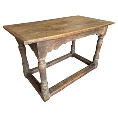 an old wooden table with turned legs