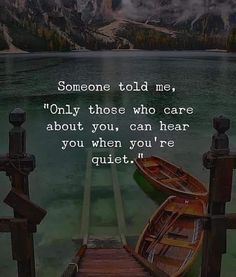 two small boats sitting on top of a pier next to the ocean with a quote about someone told me, only those who care about you can hear you when you're quiet