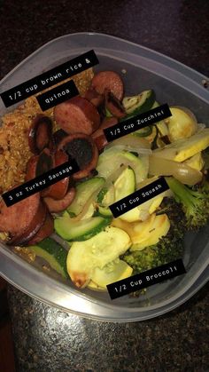 a plastic container filled with lots of different types of food on top of a table